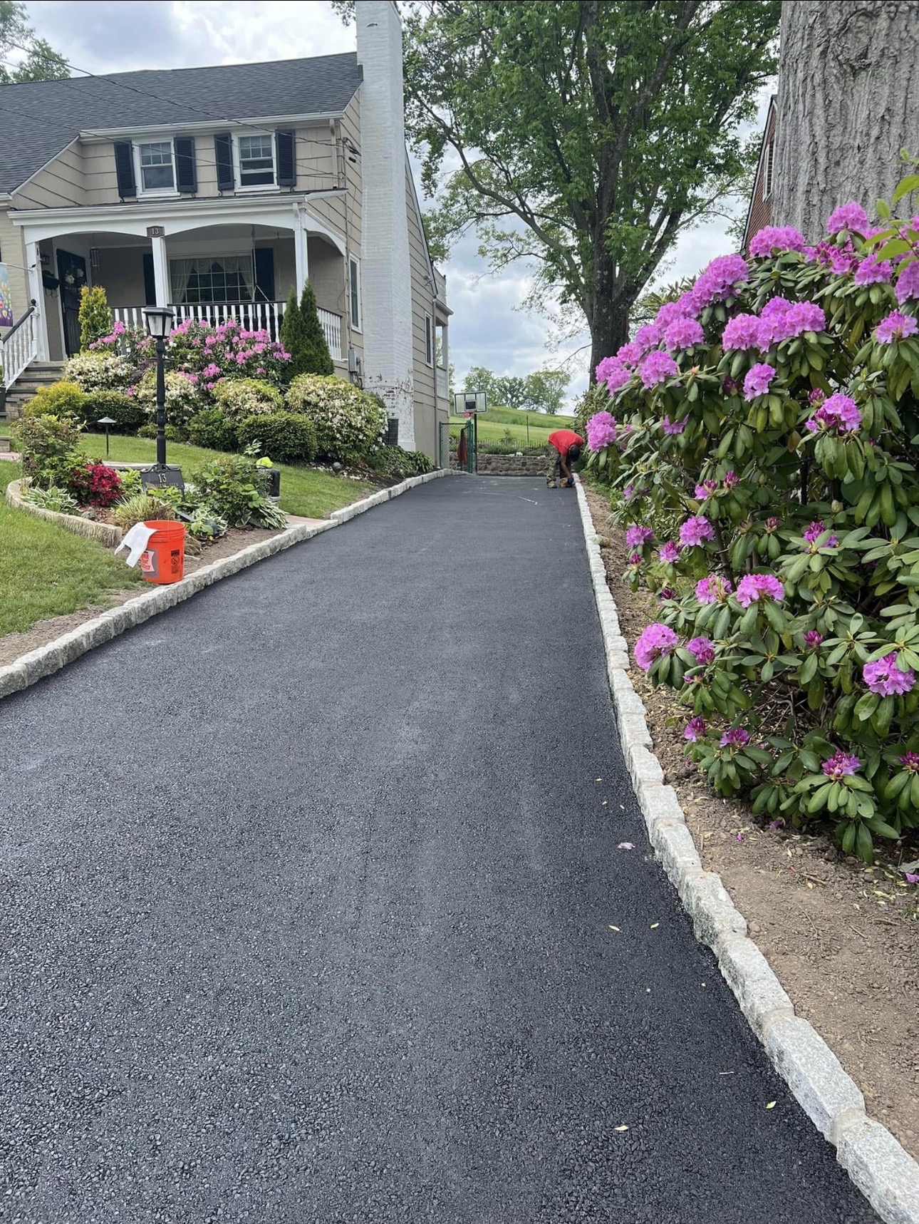 Residential asphalt driveway finished with Belgian block edging
